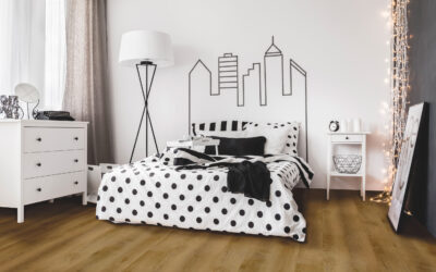 Bright bedroom interior with wide bed, commode and bedside cabinet